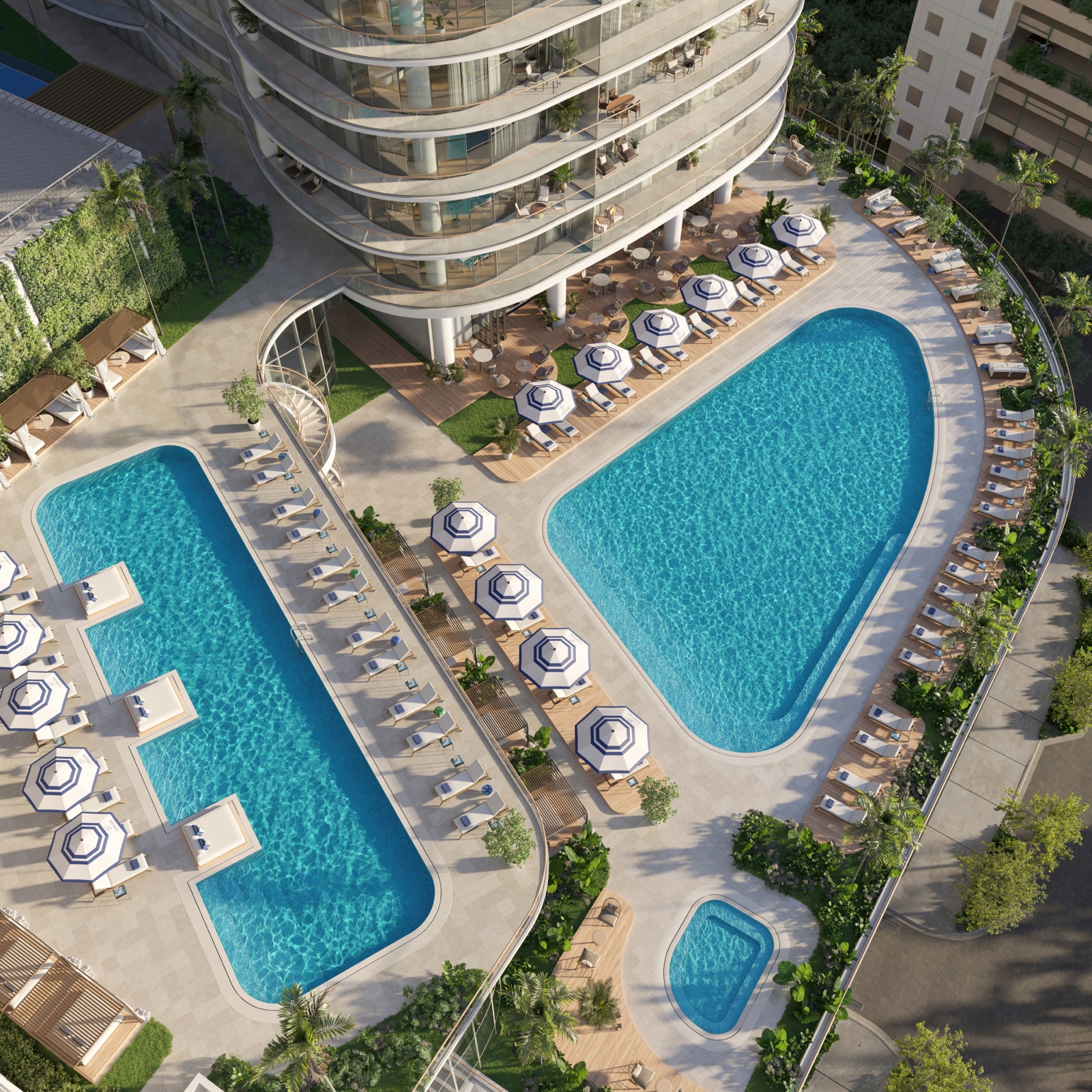 Aerial view of the elevated resort deck with two swimming pools, poolside cabanas, and outdoor spa.